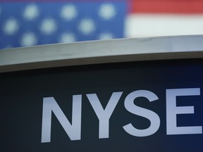 FILE- A sign for New York Stock Exchange is displayed on the floor at the NYSE in New York, Wednesday, July 27, 2022. Stocks were modestly higher early Friday, July 29, 2022, on Wall Street, despite news that closely watched inflation data jumped by the most in four decades last month.