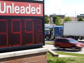 FILE - The price of regular unleaded gas is advertised for just under $4 a gallon at a Woodman's, Wednesday, July 20, 2022, in Menomonie Falls, Wis. Falling gas prices gave Americans a slight break from the pain of high inflation last month, though the surge in overall prices slowed only modestly from the four-decade high it reached in June.