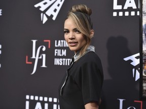 FILE - Leslie Grace arrives at a screening of "In the Heights" during the Los Angeles Latino International Film Festival on June 4, 2021. Warner Bros. has axed the $90 million "Batgirl" film planned for HBO Max, according to a person connected with the film who was not authorized to speak publicly about it. The studio decided the film, starring Grace in the title role, didn't merit either a streaming debut or a theatrical release, and has instead opted to entirely write off the film which also starred Michael Keaton, J.K. Simmons and Brendan Fraser.