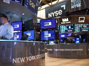 FILE - Traders work on the floor at the New York Stock Exchange in New York, Aug. 10, 2022. Stocks are opening lower on Wall Street, continuing to add to their losses following a drop last week as traders realized how determined the Federal Reserve is to keep interest rates high to fight inflation.