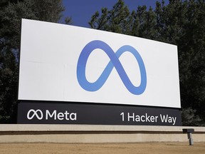 FILE - Facebook's Meta logo sign is seen at the company headquarters in Menlo Park, Calif. on Oct. 28, 2021. Facebook parent Meta says it has removed a network of accounts linked to the Proud Boys, a far-right extremist group it banned in 2018. Meta said on Thursday, Aug. 25, 2022, that it recently uncovered and removed about 480 Facebook and Instagram accounts, pages and groups linked to the Proud Boys.