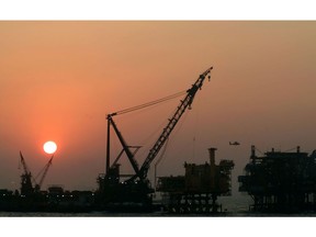 The sun sets behind an Oil & Natural Gas Corp. oil drilling platform at Bombay High, India's biggest offshore oil field, off the coast of Mumbai, India.