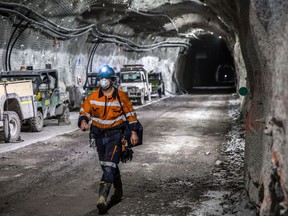 A worker walks through a tunnel towards elevators following a shift in the underground mining project at the Oyu Tolgoi copper-gold mine
