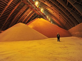 A worker walks in the warehouse at Nutrien's Cory potash mine near Saskatoon, Saskatchewan. Nutrien has increased potash production to compensate for supplies cut off by the Russian, Ukraine conflict.