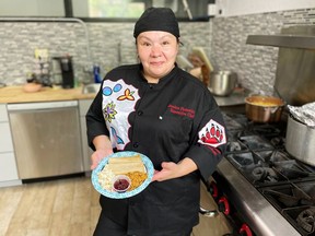 Jessica Pamonicutt, executive chef of a Native American catering company in Chicago, displays the contemporary indigenous meal she cooked for Elders at the American Indian Center of Chicago, on Aug. 3, 2022.