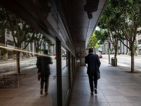 A pedestrian on California Street in the financial district of San Francisco, California.