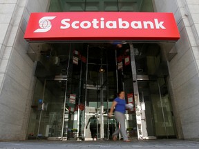 A person leaves a Bank of Nova Scotia bank in Ottawa.