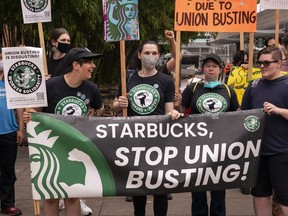Demonstrators protest outside a closed Starbucks in Seattle, Wash. in July. The group supporting the union drive alleges that Starbucks has closed stores to thwart unionization efforts. The company denies the allegations.