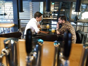 This handout photo released on the official Twitter account of Prime Minister Justin Trudeau shows Trudeau, left, meeting with Chile's president, Gabriel Boric, at a brewery in Ottawa, on June 6, 2022.