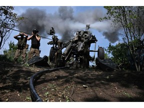 Ukrainian gunmen fire a US made M777 howitzer on the front line in Kharkiv region on August 1, 2022. Photographer: Sergey Bobok/AFP/Getty Images