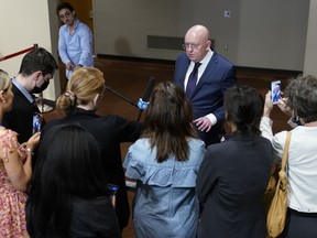Russian Ambassador to the United Nations Vasily Nebenzya, center, speaks to reporters after a Security Council meeting on threats to international peace and security, Thursday, Aug. 11, 2022 at United Nations headquarters.