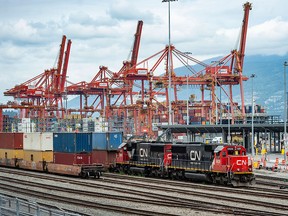 A CN Rail train loads with containers at the Port of Vancouver in June.