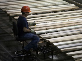 An employee monitors production at the West Fraser Timber Co. sawmill in Quesnel, B.C., in 2013.