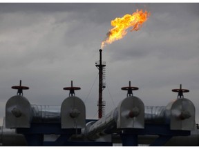 A gas flare burns at the central processing plant for oil and gas in the Salym oilfields near Surgut, Russia. Photographer: Alexander Zemlianichenko Jr/Bloomberg