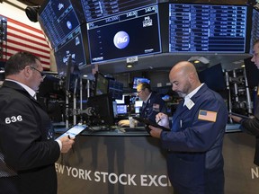 In this photo provided by the New York Stock Exchange, traders work on the floor of the exchange on Tuesday, Sept. 13, 2022. Stock markets in Canada and the U.S. were under pressure last week after the U.S. Federal Reserve raised its key interest rate by three-quarters of a percentage point and forecast more hikes are to come.
