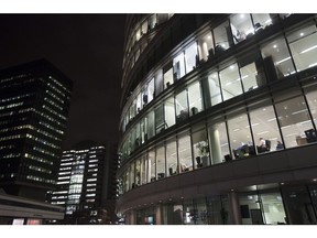 Electrical lights illuminate offices inside a commercial building at night in London, U.K., on Thursday, Nov. 17, 2016. More than 1,900 firms are likely to review their office-space requirements in London following the U.K.'s decision to leave the European Union. Photographer: Simon Dawson/Bloomberg