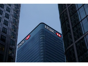 Logos sit illuminated on the HSBC Holdings Plc headquarter skyscraper offices in the Canary Wharf business, financial and shopping district in London.