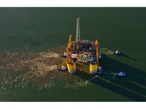 Tugboats transport the Hess Corp tension leg oil rig. Stampede, towed from Kiewit Offshore Services Ltd., in this aerial photograph taken over Ingleside, Texas, U.S., Friday, May 5, 2017. The Stampede deepwater oil and gas field is one of the largest undeveloped fields in the Gulf of Mexico, 185 km south of Fourchon, Louisiana. Photographer: Eddie Seal/Bloomberg