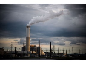 Emissions rise from the Duke Energy Corp. coal-fired Asheville Power Plant ahead of Hurricane Florence in Arden, North Carolina, U.S., on Thursday, Sept. 13, 2018. Hurricane Florence's wrath hit the North Carolina coast, but the full effects of the storm, still centered 100 miles from shore, are yet to come.