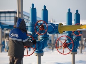 A worker turns a valve wheel in the yard at the Gazprom PJSC Atamanskaya compressor station, part of the Power Of Siberia gas pipeline, near Svobodny, in the Amur region, Russia, on Wednesday, Dec. 11, 2019. The pipeline, which runs from Russia's enormous reserves in eastern Siberia and will eventually be 3,000 kilometers (1,900 miles) long, will help satisfy China's vast and expanding energy needs.