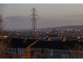 Electrical power lines hang from a transmission pylon among houses looking towards Belfast Harbour in Belfast, Northern Ireland, U.K., on Friday, Jan. 3, 2020. With the U.K. due to leave the European Union, questions remain over trading agreements and Ireland's 12-year-old single electricity market, known as the SEM.