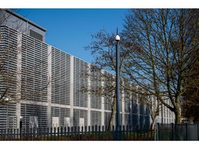 A security camera hangs from a pole in front of JPMorgan Chase & Co.'s data center in Basingstoke, U.K., on Friday, March 6, 2020. As the coronavirus outbreak grows, London's banks are rolling out ever more geographically sprawling contingency plans.