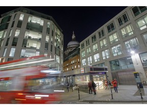 A bus passes St Paul's London Underground station at dusk in the City of London, U.K., on Monday, March 16, 2020. While the U.K. authorities have abandoned efforts to contain the coronavirus, focusing on delaying the worst of the outbreak, financial-services companies are grappling with policy as several offices cope with health scares. Photographer: Luke MacGregor/Bloomberg