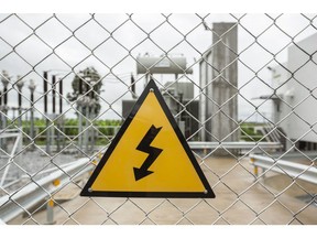 An electricity warning sign is displayed on a fence at an electrical substation at the Krissana Wind Co. NKS wind farm, owned by Wind Energy Holding Co., in Nakhon Ratchasima Province, Thailand, on Friday, Oct. 16, 2020. Solar power will remain the biggest driver of new renewable energy capacity in Southeast Asia over the next few years. Though some wind projects are expected to come online too, and there are signs of early stage offshore wind developments in Vietnam and the Philippines. Photographer: Andre Malerba/Bloomberg