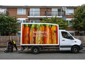 An employee of J Sainsbury Plc unloads a grocery delivery in London U.K., on Wednesday, Sept. 30, 2020. Covid-19 lockdown enabled online and app-based grocery delivery service providers to make inroads with customers they had previously struggled to recruit, according the Consumer Radar report by BloombergNEF.