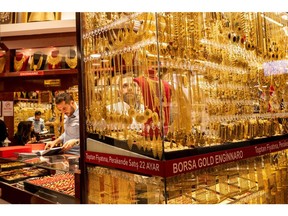 A worker inspects gold items displayed in the window of a jewelry shop inside the Grand Bazaar in Istanbul, Turkey, on Wednesday, June 2, 2021. Turkish President Recep Tayyip Erdogan renewed calls for lower interest rates despite elevated inflation, sending the lira to a fresh low against the dollar and prompting the central bank governor to push back against expectations of an imminent move.
