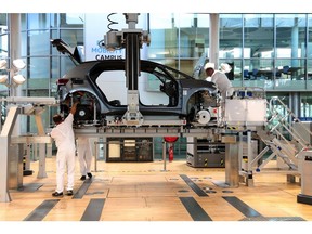 Workers assemble a Volkswagen AG (VW) ID.3 electric automobile on the production line at the automaker's factory in Dresden, Germany, on Tuesday, June 8, 2021. VW's supervisory board is proposing to investors to extend the contract of Chairman Hans Dieter Poetsch and board member Louise Kiesling for another term of five years at the next annual meeting, a spokesman said.