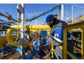 A worker adjusts a valve wheel on a section of pipework at the Comprehensive Gas Treatment Unit No.3 at the Gazprom PJSC Chayandinskoye oil, gas and condensate field, a resource base for the Power of Siberia gas pipeline, in the Lensk district of the Sakha Republic, Russia, on Monday, Oct. 11, 2021. Amid record daily swings of as much as 40% in European gas prices, Russian President Vladimir Putin made a calculated intervention to cool the market last week by saying Gazprom can boost supplies to help ease shortages.