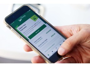 A customer checks their payments on the OVO Energy Ltd. app on a smartphone arranged in Danbury, U.K., on Thursday, Oct. 21, 2021. European energy prices soared to fresh records amid worsening fears over supply, with U.K. natural gas futures exceeding the threshold of 300 pence a therm for the first time ever.