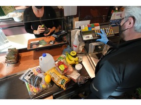 A cashier assists a customer at a checkout counter at Harmons Grocery store in Salt Lake City, Utah, U.S., on Thursday, Oct. 21, 2021. More than a year and a half after the coronavirus pandemic upended daily life, the supply of basic goods at U.S. grocery stores and restaurants is once again falling victim to intermittent shortages and delays. Photographer: George Frey/Bloomberg