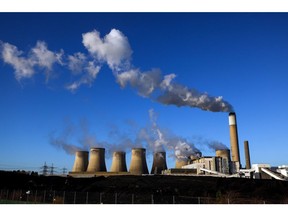 Piles of coal next to cooling towers at Uniper SE's coal-fired power station in Ratcliffe-on-Soar, U.K., on Thursday, Dec. 2, 2021. The recent drop in prices for coal and U.S. gas, as well as limited interest for LNG cargoes from some buyers in Asia, opened the way for added supply into Europe.