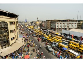 Taxi vans in heavy traffic on Nnamdi Azikwe Street by Idumota market in Lagos, Nigeria, on Thursday, Jan. 6, 2022. Nigeria's Lagos state government plans to build new roads, rail, housing, health, education and waterways infrastructure to boost businesses and improve living standards.