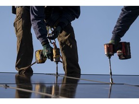 Contractors install SunRun solar panels on the roof of a home in San Jose, California, U.S., on Monday, Feb. 7, 2022. California regulators are delaying a vote on a controversial proposal to slash incentives for home solar systems as they consider revamping the measure. Photographer: David Paul Morris/Bloomberg