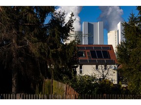 Lippendorf Power Station - lignite-fired power station (operated by LEAG), high voltage electricity power lines and solar panels on a rooftop of a residential house.. Lippendorf, Germany02.03.2022.Photo: Krisztian Bocsi