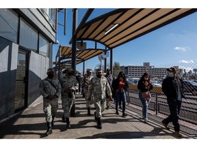 Members of the Mexican National Guard patrol the San Ysidro Port of Entry border crossing bridge in Tijuana, Mexico, on Sunday, March 20, 2022. In FY22 so far, the number of Ukrainians and Russians encountered at the border has already surpassed the previous two years, with the most significant uptick happening in the last six months, as Russia's threats against Ukraine increased, according to a TIME analysis of CBP data.