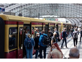 Passengers board a train at Berlin Central Station in June. Photographer: Krisztian Bocsi/Bloomberg