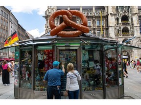 Customers look at Germany and Munich themed stickers, badges and other mementos at a souvenir kiosk in Munich, Germany, on Saturday, June 11, 2022. Confidence in the German economy improved a little, while remaining depressed, as fewer investors predict the outlook will deteriorate further in the face of record inflation and the war in Ukraine.