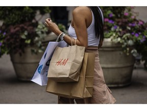 A shopper carries an H&M bag in New York, US, on Thursday, July 28, 2022. Consumer spending slowed to a 1% annualized growth rate from 1.8% for the first quarter. Photographer: Victor J. Blue/Bloomberg