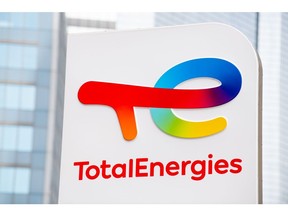 Signage for TotalEnergies SE at the company's electric vehicle charging station in the La Defense business district in Paris, France, on Thursday, July 28, 2021. TotalEnergies will extend its $2 billion buyback program into the third quarter after profit surged to a record, propelled by surging gasoline prices and soaring demand for natural gas in Europe. Photographer: Benjamin Girette/Bloomberg
