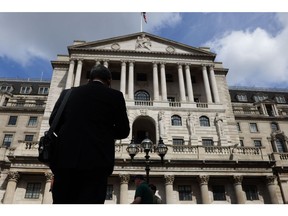 A city worker outside the Bank of England (BOE) ahead of the Monetary Policy Report news conference at the bank's headquarters in the City of London, UK, on Thursday, Aug. 4, 2022. Photographer: Hollie Adams/Bloomberg