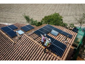 Engineers from Sud Energies Renovables SL install solar panels onto the roof of a residential property in Barcelona, Spain, on Wednesday, Sept. 7, 2022. Spain and other Mediterranean countries generated record amounts of power from wind and solar farms, underscoring the potential for renewables to replace expensive fossil fuels.