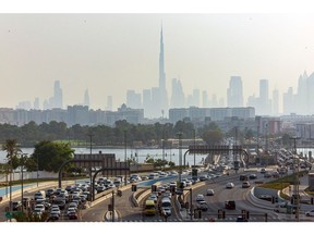 Motorists commute past the Burj Khalifa skyscraper, center, and commercial and residential properties on the city skyline in Dubai, United Arab Emirates, on Thursday, Sept. 15, 2022. Office rents in Dubai are rebounding for the first time in six years, rising faster than in New York or London as global banks and businesses expand into the financial hub known for its love of glitzy construction. Photographer: Christopher Pike/Bloomberg