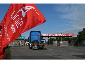 A lorry passes a Unite union banner at the Port of Liverpool during a strike in Liverpool, UK, on Tuesday, Sept. 20, 2022. Dockers at Britain's fourth-biggest container port voted unanimously to reject their employer's latest pay offer -- and walk off the job for two weeks in a strike that gets into full swing on Tuesday. Photographer: Anthony Devlin/Bloomberg
