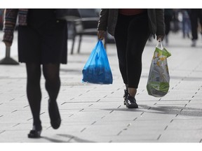 Shoppers carry plastic shopping bags in Croydon, Greater London, UK, on Monday, Sept. 26, 2022. The Bank of England may need to step in with an emergency rate rise to calm market nerves about the government's economic plans, Conservative lawmakers said after the pound tumbled to a record low against the dollar. Photographer: Jason Alden/Bloomberg