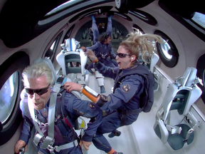 Billionaire Richard Branson with crew members Beth Moses and Sirisha Bandla on board Virgin Galactic’s passenger rocket plane VSS Unity after reaching the edge of space in July 2021.