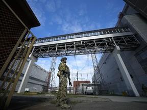 FILE - A Russian serviceman guards an area of the Zaporizhzhia Nuclear Power Station in territory under Russian military control, southeastern Ukraine, May 1, 2022. Ukraine's Zaporizhzhia nuclear power plant , built during the Soviet era and one of the 10 biggest in the world, has been engulfed by fighting between Russian and Ukrainian troops in recent weeks, fueling concerns of a nuclear catastrophe. (AP Photo, File)